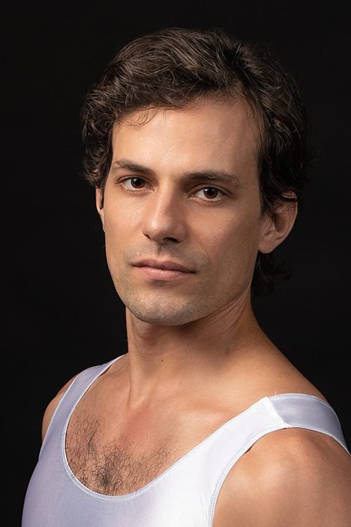 A man with a white shirt on and black background