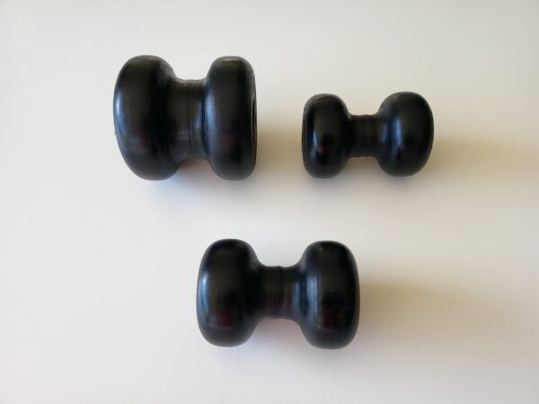 Three black knobs on a white table