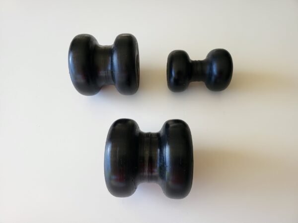 Three black knobs on a white table